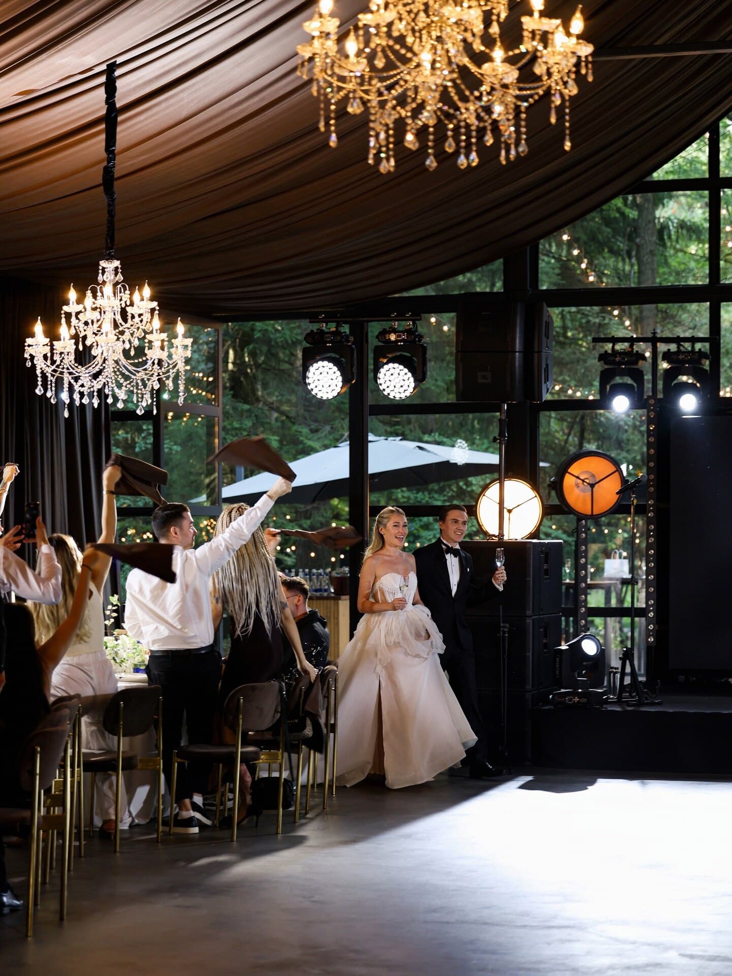 A tented reception beneath warm suspended light